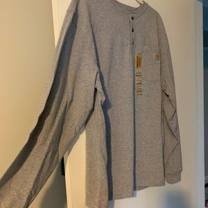 Long sleeve grey carhartt shirt with three buttons and front pocket.